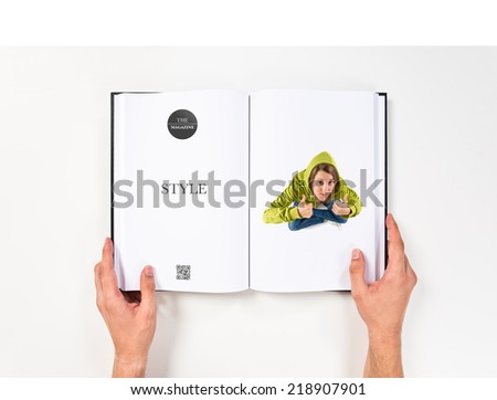 Young girl making Ok sign printed on book