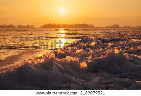 Winter landscape with sunset sky and frozen sea coast. Daybreak