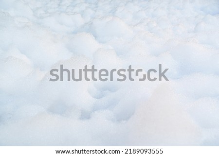 white foam for foam party. dancing to music on a dance floor covered with a few feet of foam or bubbles emitted from the foaming agent. background and texture. Royalty-Free Stock Photo #2189093555