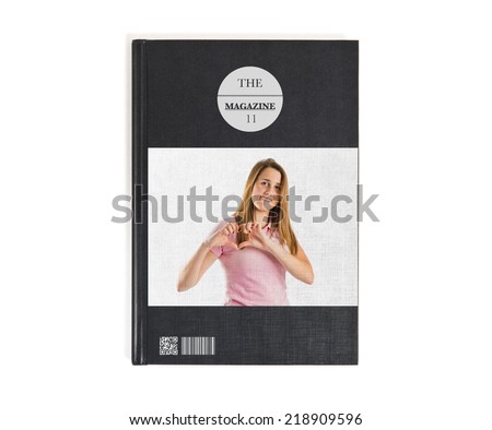 Young pretty girl make a heart with her hands printed on book