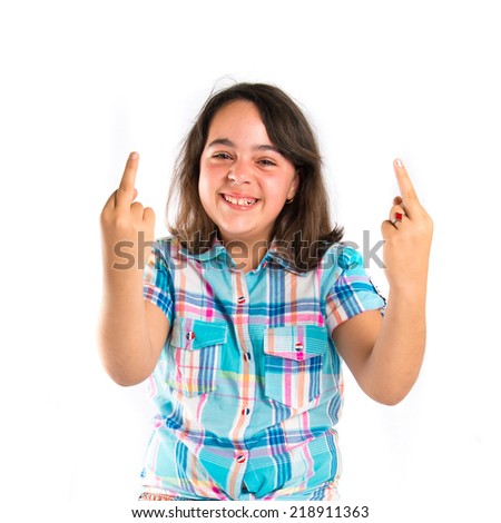 Girl making horn gesture over white background 