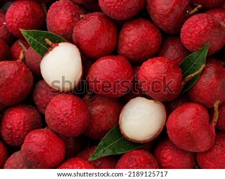 Fresh ripe lychee with water droplets for background, top view. Royalty-Free Stock Photo #2189125717