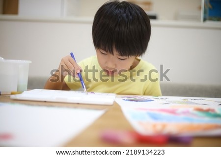 Boy drawing a picture image
