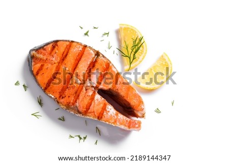 Grilled salmon fish steak isolated on white background. Roasted salmon piece - healthy food ingredient. Royalty-Free Stock Photo #2189144347
