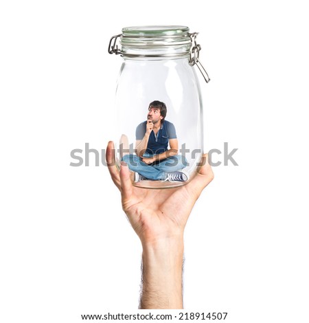 Man thinking inside jar glass