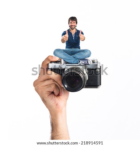 Man with thumb up sitting in camera
