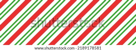 Christmas candy cane striped seamless pattern. Christmas candycane background with red and green stripes. Peppermint caramel diagonal print. Xmas traditional wrapping texture. Vector illustration. Royalty-Free Stock Photo #2189178581