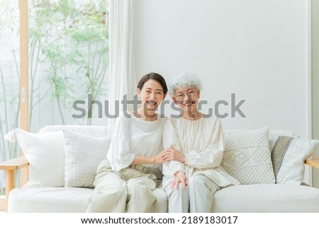 Smiling Asian mother and daughter Royalty-Free Stock Photo #2189183017