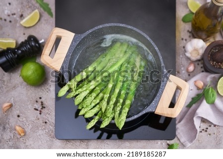 Cooking asparagus in a pot - Fresh asparagus boiled on water Royalty-Free Stock Photo #2189185287