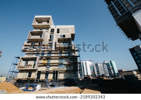a new residential complex in a modern style at the final stage of construction and landscaping. High quality photo