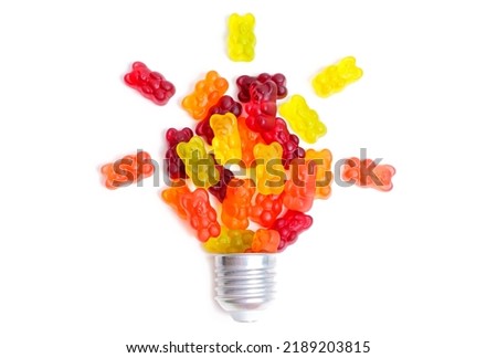 Bright gummy bears lightbulb composition isolated on white background. Boosting brain functioning with candies. Royalty-Free Stock Photo #2189203815