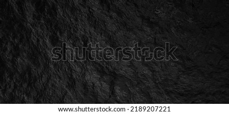 Monochromatic Close Up of Gentle Waves in Water. black water sea wave. black rock water banner and surface of dark nature background. Black texture. dark cave texture. Black wall texture. Rock. Royalty-Free Stock Photo #2189207221