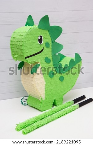 pinata toy green dinosaur on a white background