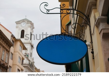 Shop sign building mockup. Store mockup blue empty sign for your logo in historic center.