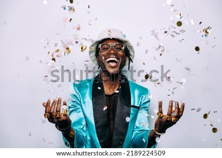 portrait of an hip hop music musician. Cinematic image of a man under confetti drop