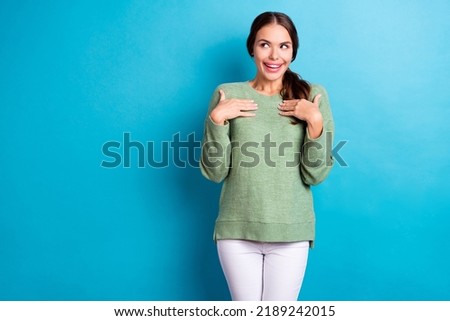 Photo of excited cheerful girl hands touch chest look interested empty space isolated on blue color background