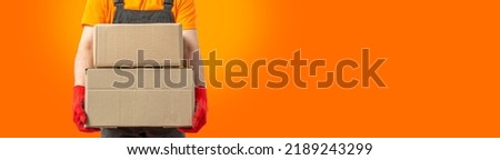 Delivery man with box. Staff laborer, orange uniform cap, t-shirt, coveralls service moving delivering orders goods. Guy holding cardboard package. Character, bright background, mockup design.