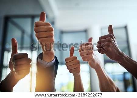 Diverse group of successful businesspeople approving and giving thumbs up for satisfaction and job well done. Corporate team of cheerful colleagues using their hands to say yes showing agreement Royalty-Free Stock Photo #2189252077