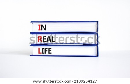 IRL in real life symbol. Concept words IRL in real life on books on a beautiful white table white background. Business and IRL in real life concept. Copy space.