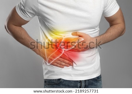 Man suffering from liver pain on grey background, closeup Royalty-Free Stock Photo #2189257731