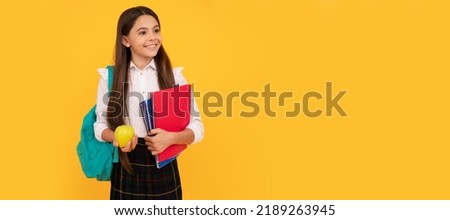 happy child with backpack and workbooks hold apple lunch in school uniform. Banner of school girl student. Schoolgirl pupil portrait with copy space. Royalty-Free Stock Photo #2189263945
