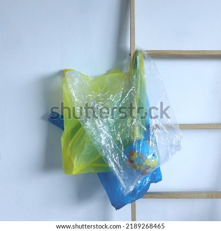 A hanging transparent plastic bag with globe. Global warming concept. Plastic pollution ecology problem.