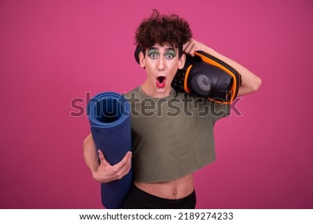 Fitness and healthy lifestyle. Sporty funny drag queen. Pink background.	