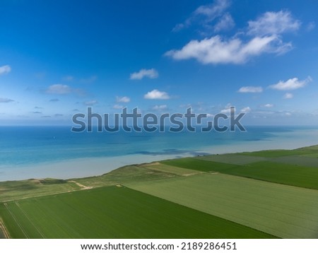 Aerial view on green grain fields and blue Atlantic ocean in agricultural region Pays de Caux in Normandy, France in summer Royalty-Free Stock Photo #2189286451