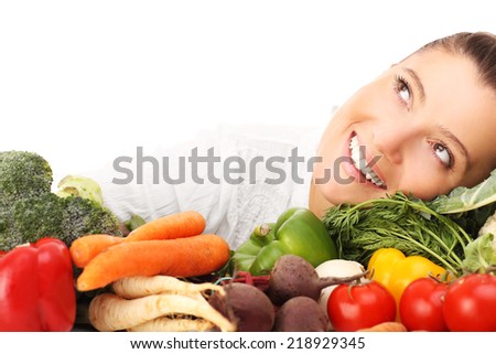 A picture of a happy woman with vegetables over white background
