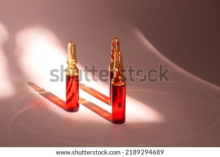injections of B vitamins. Ampoules with red liquid. Beauty and health concept Royalty-Free Stock Photo #2189294689