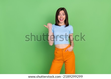 Photo of young attractive gorgeous nice woman unbelievable sale pointing empty space isolated on green color background