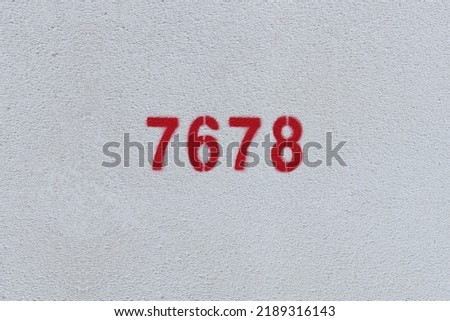 Red Number 7678 on the white wall. Spray paint.
