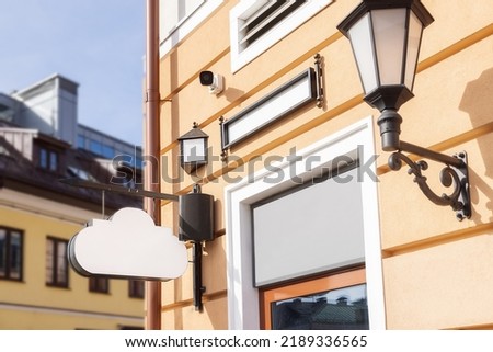 mockup for title, logo. white sign in the form of a cloud on an old building