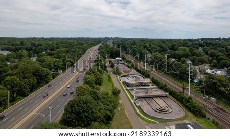 An aerial view over the Interstate 95 highway which is elevated to cross the Suagatuck River in CT on a bright sunny day. Royalty-Free Stock Photo #2189339163