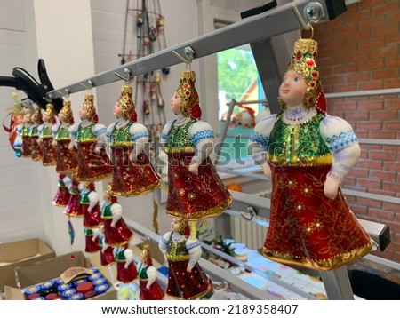 a set of New Year and Christmas toys a girl in a folk costume drying after coloring