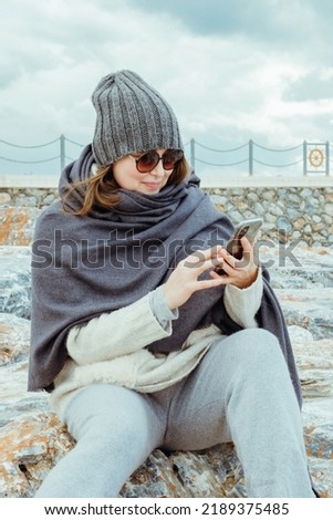 Modern young woman using mobile phone. Stylish girl size plus using phone. 