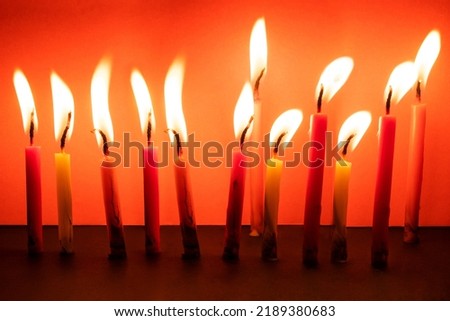 Burning Candles Against Color Background during diwali festival