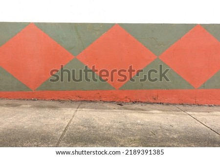 
close-up view of a sidewalk from the side in front of a colorful house facade. No people in the picture. The pavement is suitable as a product stage or for composings