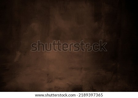 Dark brown painted background with black shadows on both sides. Royalty-Free Stock Photo #2189397365