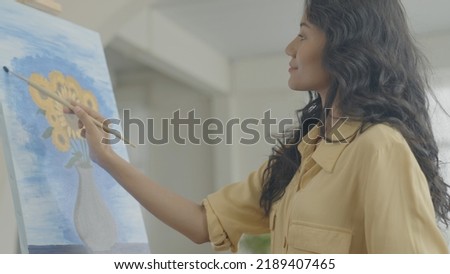 Artist concept of 4k Resolution. Asian woman drawing in the living room. Artist is creating work. Leisure activities and hobbies.