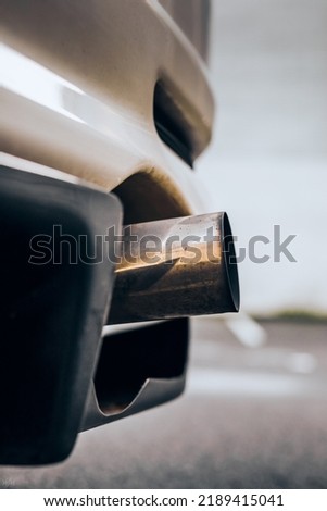 Custom exhaust pipe sticking out past the car bumper