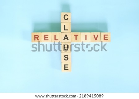 Relative clause concept in English grammar education. Wooden block crossword puzzle flat lay in blue background. Royalty-Free Stock Photo #2189415089