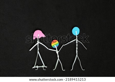 LGBT or LGBTQIA child support and acceptance concept. Family stick figure with gay son in dark black background.