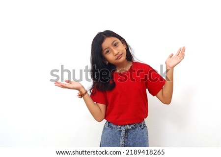 Asian little girl standing with confused gesture. Isolated on white background