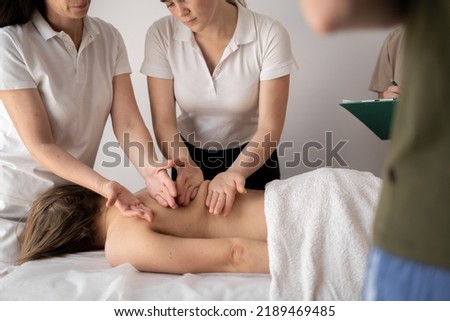 Teacher helping student training to become masseus, health wellness massage training concept Royalty-Free Stock Photo #2189469485