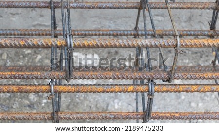 Rusty metal reinforcement bars at construction site - From above of weathered solid metal armature rods for foundation of building under construction.
