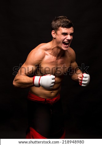 Male model. Kickboxing. Located on the back background.
