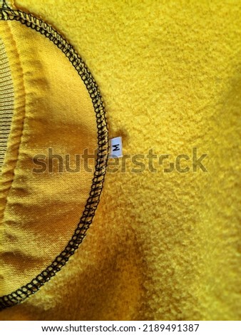 size M marks for clothes that are usually placed on the back and inside of shirts, jackets and others