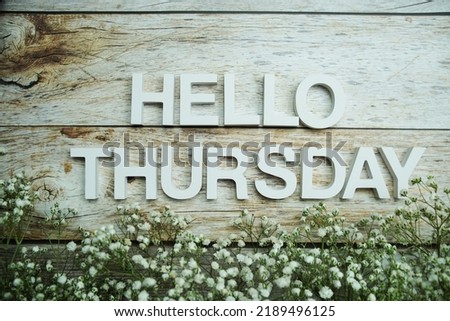 Hello Thursday alphabet letters on wooden background