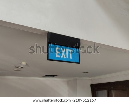 exit sign on office building ceiling